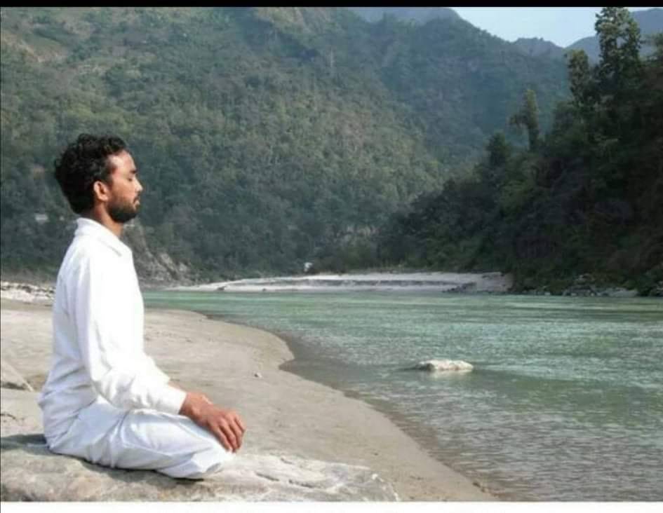 Harish chandra doing meditation during dunset in rishikesh