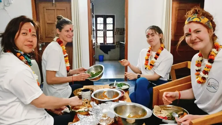 Four Yoga students taking meal during 200 hour yoga teacher training course in Rishikesh India