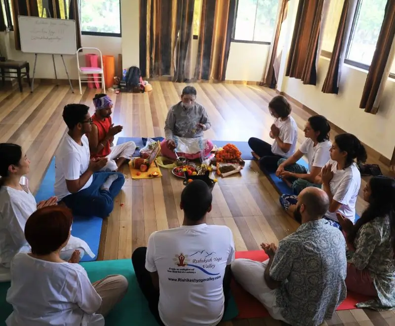 Yoga students participating in a traditional opening ceremony during the 200 Hour Yoga Teacher Training at Rishikesh Yoga Valley, India.