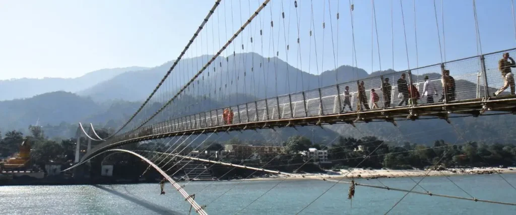 Scenic Ganges river in Rishikesh, with mountains and lush landscapes in the background