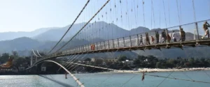 Scenic Ganges river in Rishikesh, with mountains and lush landscapes in the background