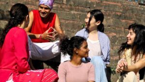 yoga students having conversation with kamal negi, yoga instructor and owner of Rishikesh Yoga Valley School