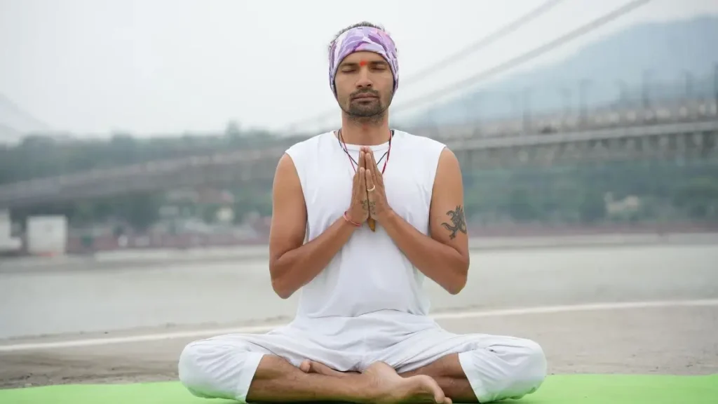 Kamal Negi the found of Rishikesh Yoga Valley School meditating near Ganga river, Laxman jhula, tapovan, rishikesh, uttarakhand, India