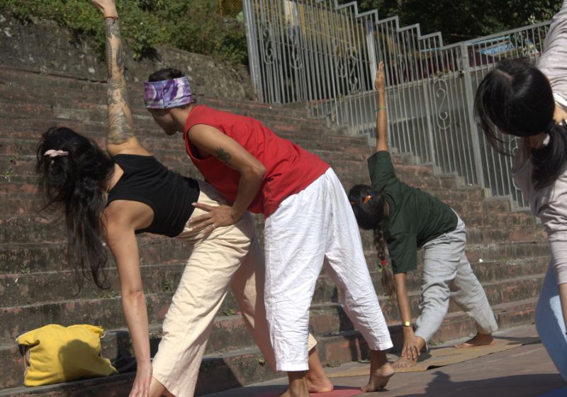 Yogi kamal ji adjusting yoga student alignment