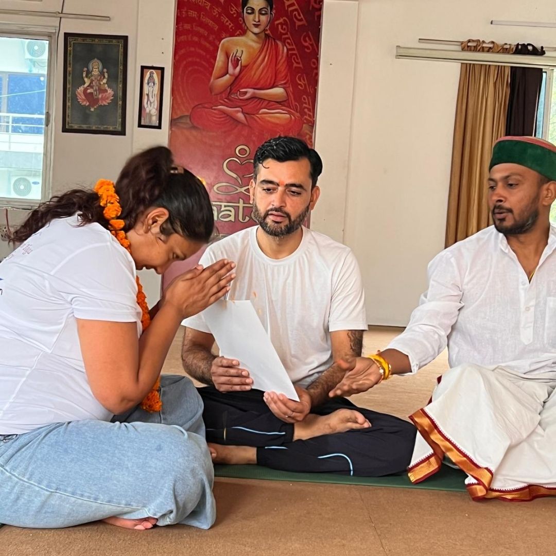 Yoga Teacher Giving certificate to yoga student