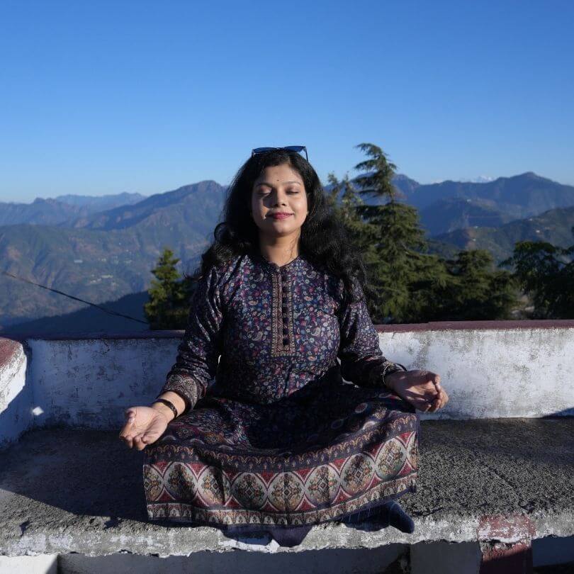 7 days yoga student meditating at sunset in kunjapoori, rishikesh