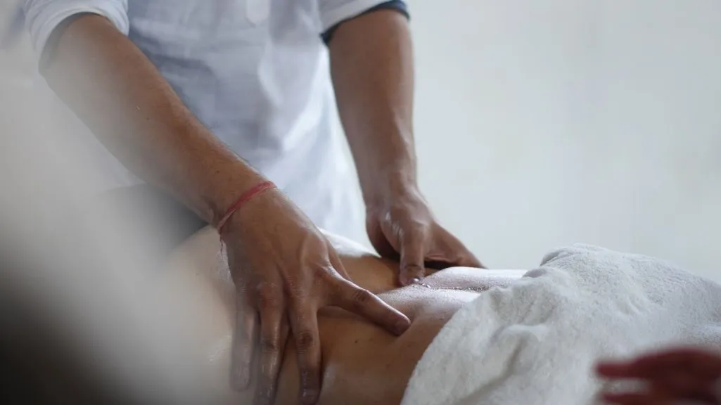 Professional therapist giving an Ayurvedic oil massage during a 10 days Ayurveda and yoga retreat in Rishikesh India.