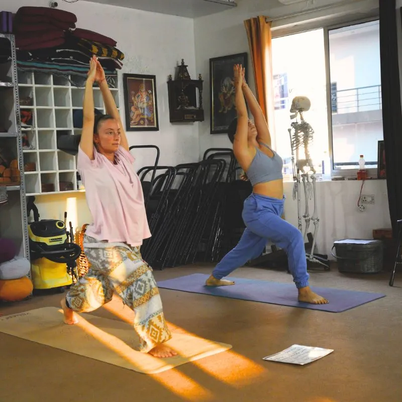 Students practicing Warrior pose during a 100 hour yoga teacher training in Rishikesh India.