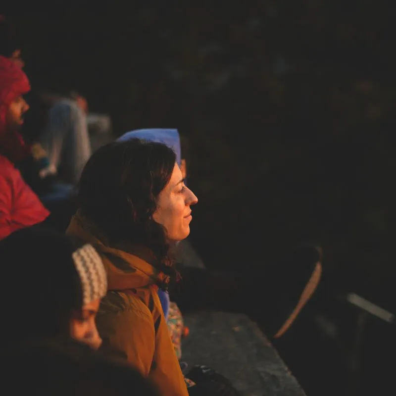 Yoga instructor guiding a student in proper posture alignment during 100 hour yoga teacher training in Rishikesh India inside a traditional yoga studio.