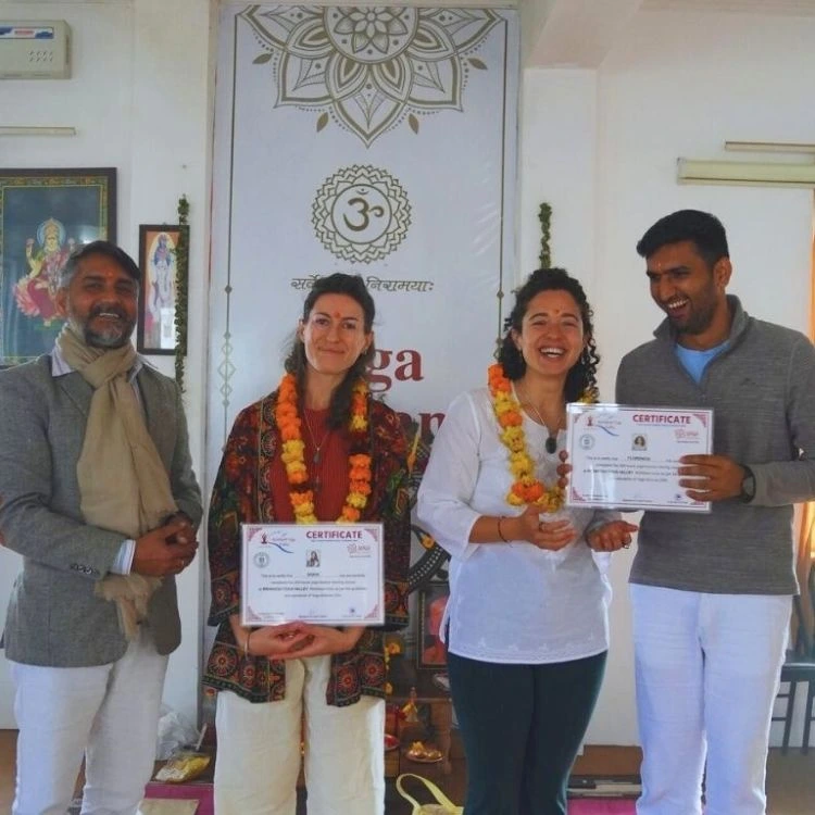 Students receiving certificates after completing 300 hour yoga teacher training in Rishikesh, India.