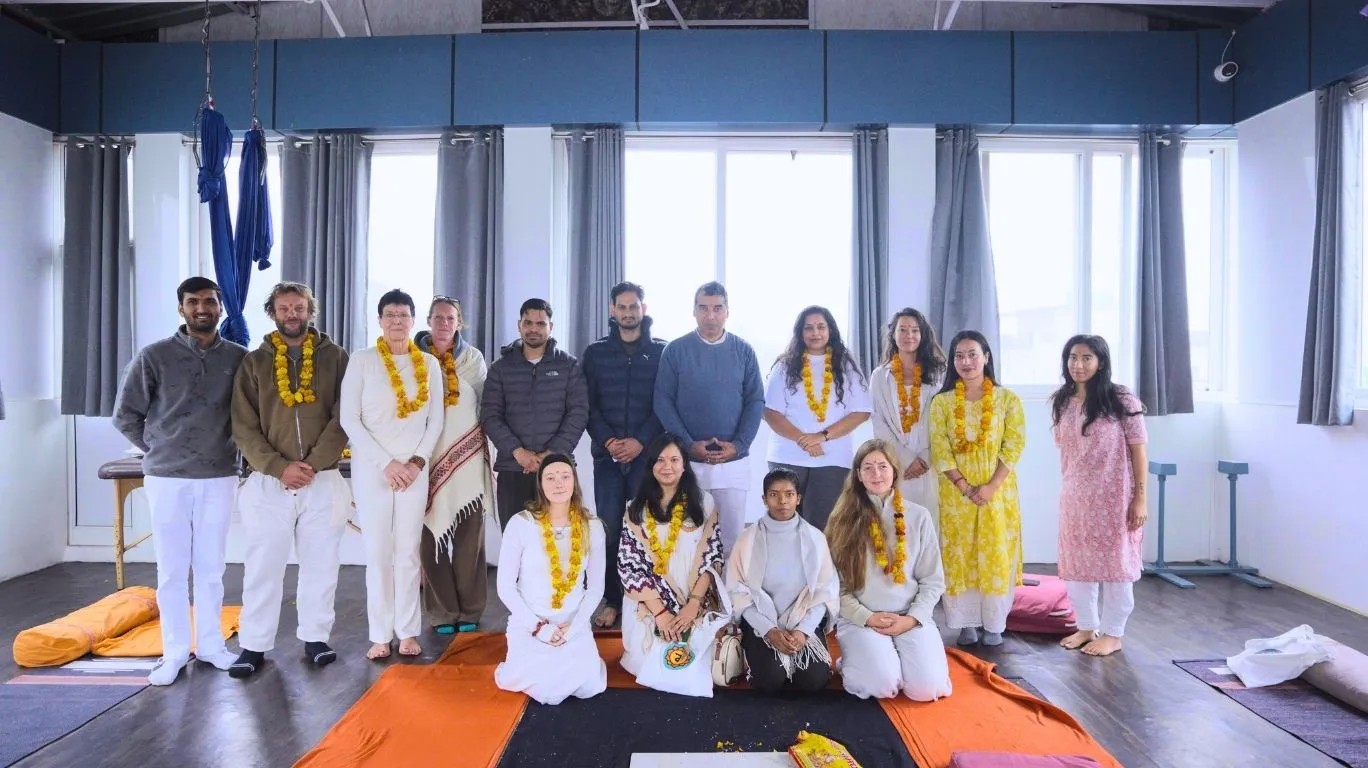 50 Hour Yoga Teacher Training in Rishikesh India group photo with international students during yoga certification ceremony with flower garlands