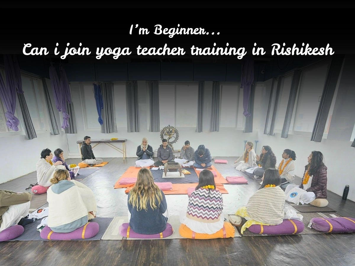 Beginner students attending a yoga teacher training for beginners orientation session in Rishikesh, India, sitting in a meditation circle with instructors at a yoga ashram.