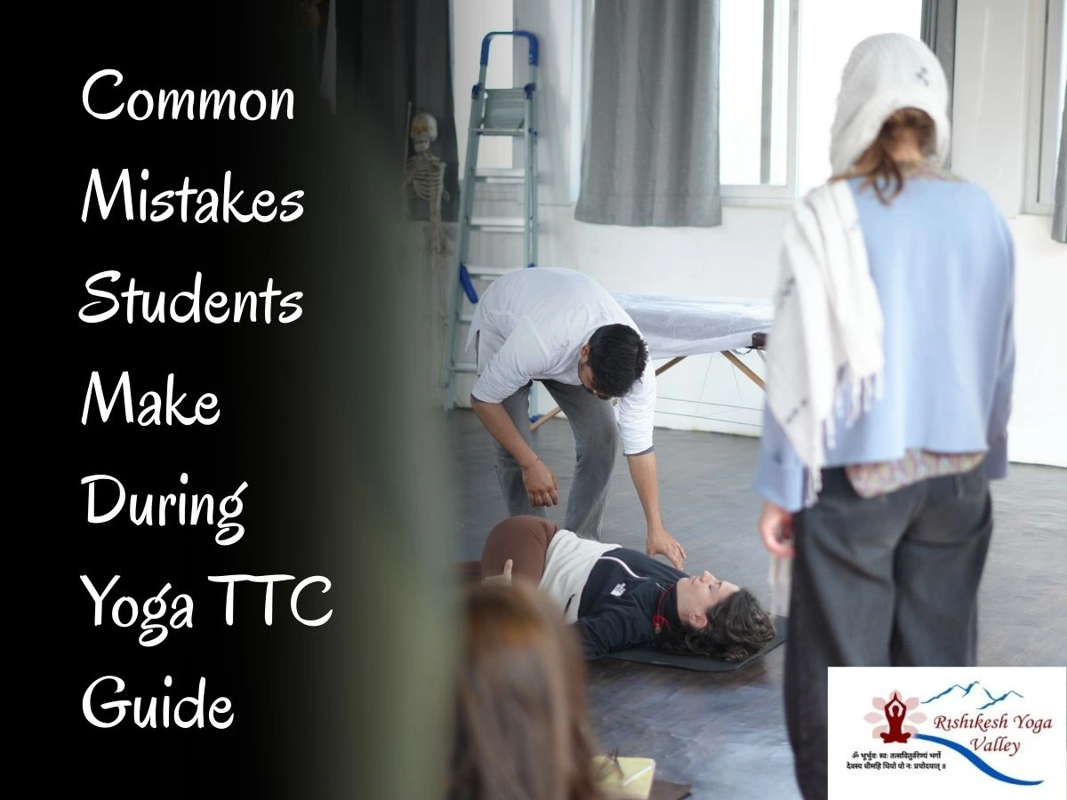 Yoga teacher adjusting a student during yoga teacher training while explaining common mistakes students make during yoga TTC.