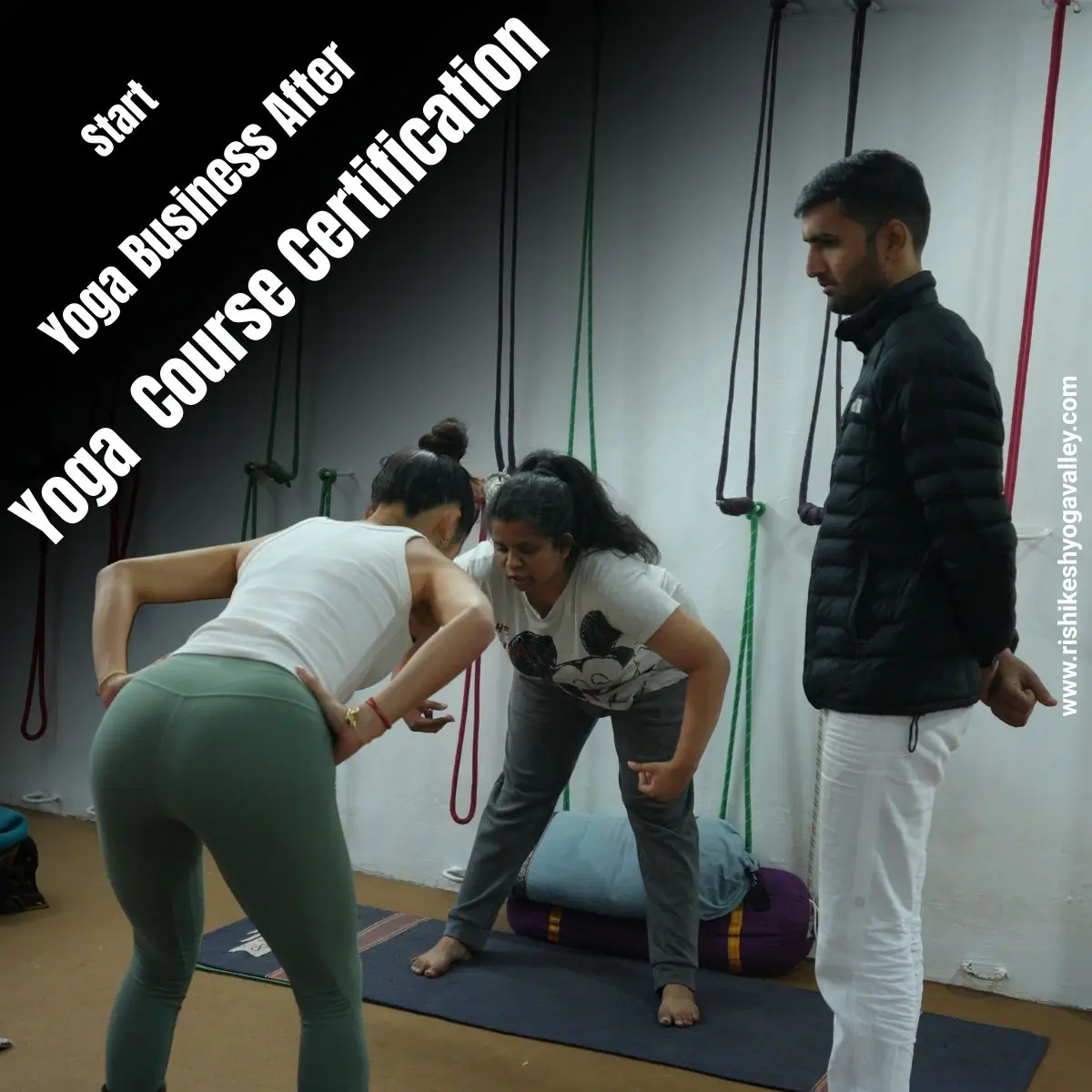 Yoga instructor guiding a student during practical training while discussing how to build a yoga business after certification during yoga teacher training.