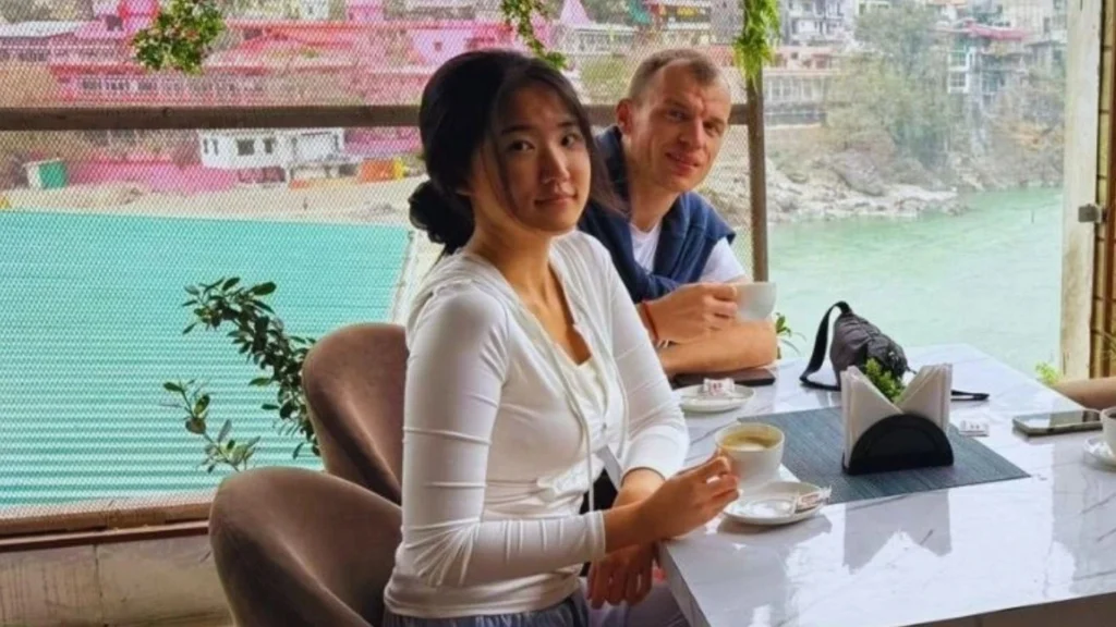 International students enjoying tea at a riverside cafe with a view of the Ganga River in Rishikesh