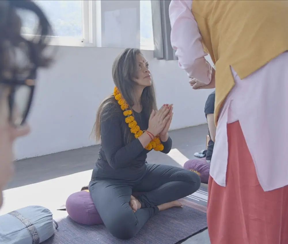 International yoga student receiving traditional welcome during yoga teacher training in Rishikesh India