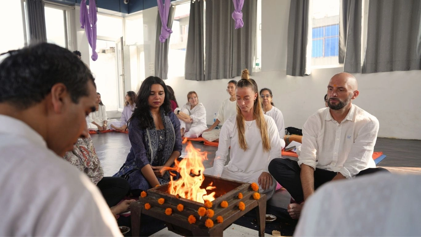 Students participating in a sacred fire ceremony during the 100 Hour Kundalini Yoga Teacher Training in Rishikesh India