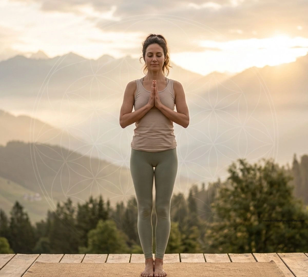 Woman practicing Pranamasana (Prayer Pose) yoga at sunrise with mountain background in calm natural setting.