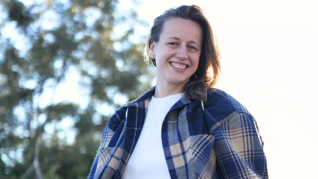 A happy participant enjoying the peaceful atmosphere during a 7 days yoga retreat in Rishikesh, India.