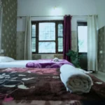 Spacious and clean student accommodation room at yoga school in Rishikesh India during 50 hour yoga teacher training