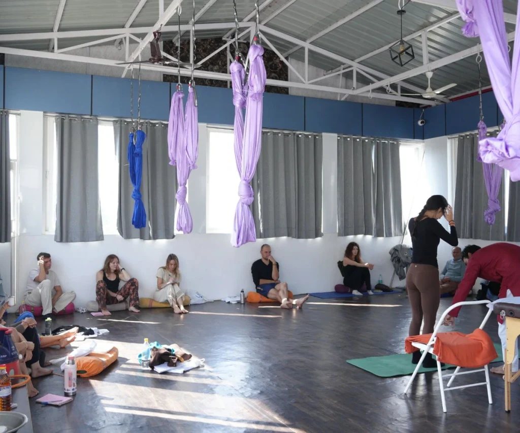 Students attending a yoga teacher training class session while learning techniques and avoiding common mistakes during yoga TTC.