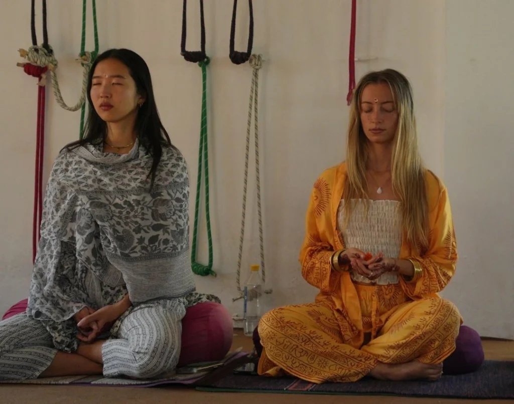 Students practicing meditation during yoga teacher training to develop mindfulness and mental clarity.