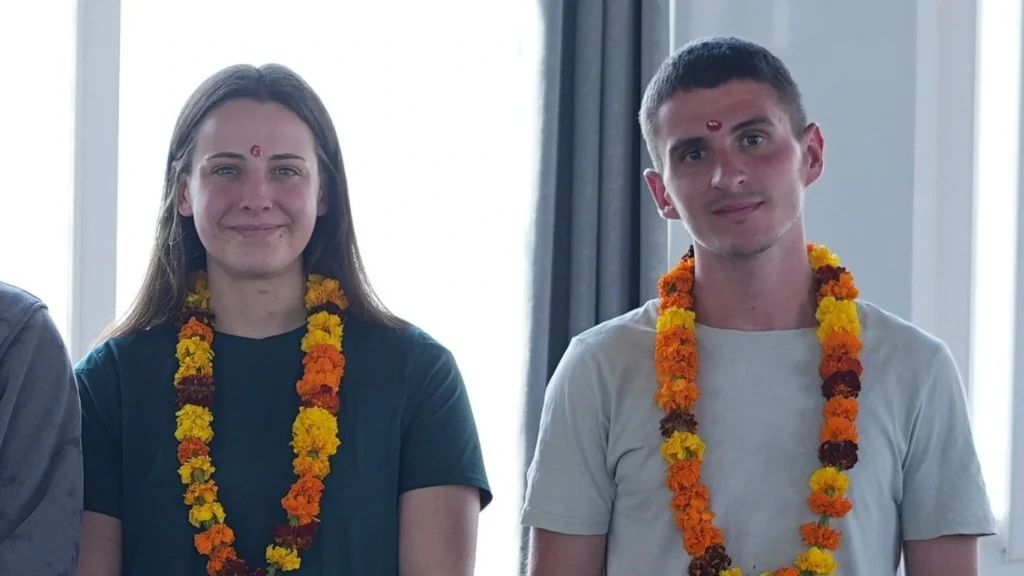 Yoga teacher training students wearing traditional garlands after completing yoga course in Rishikesh, India.