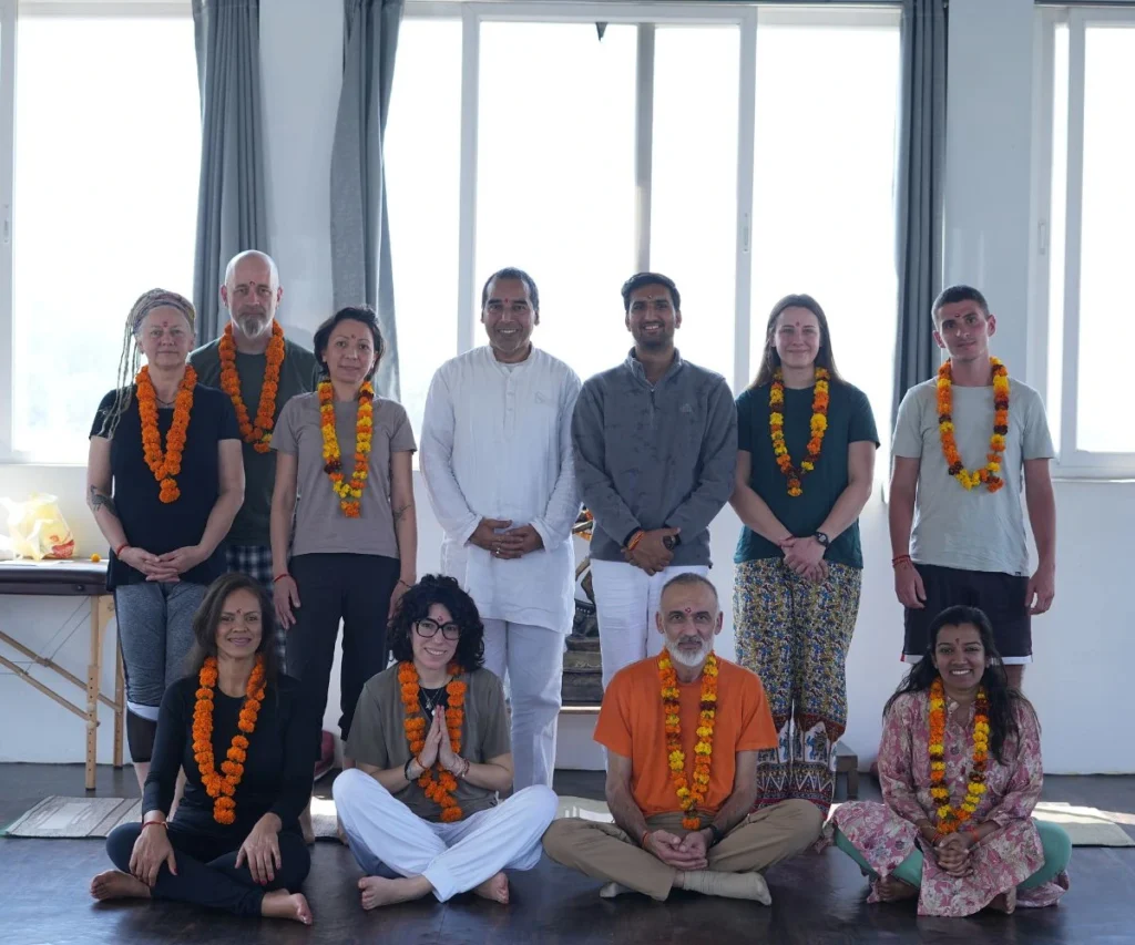 Yoga teacher training students and teachers group photo after completing yoga course in Rishikesh, India.