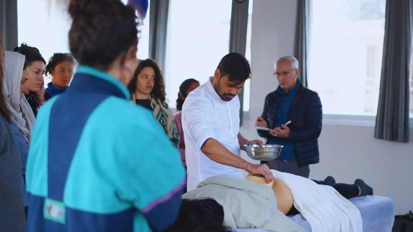 Students observing an Ayurveda practical demonstration during a 500 hour Yoga Teacher Training in Rishikesh India.