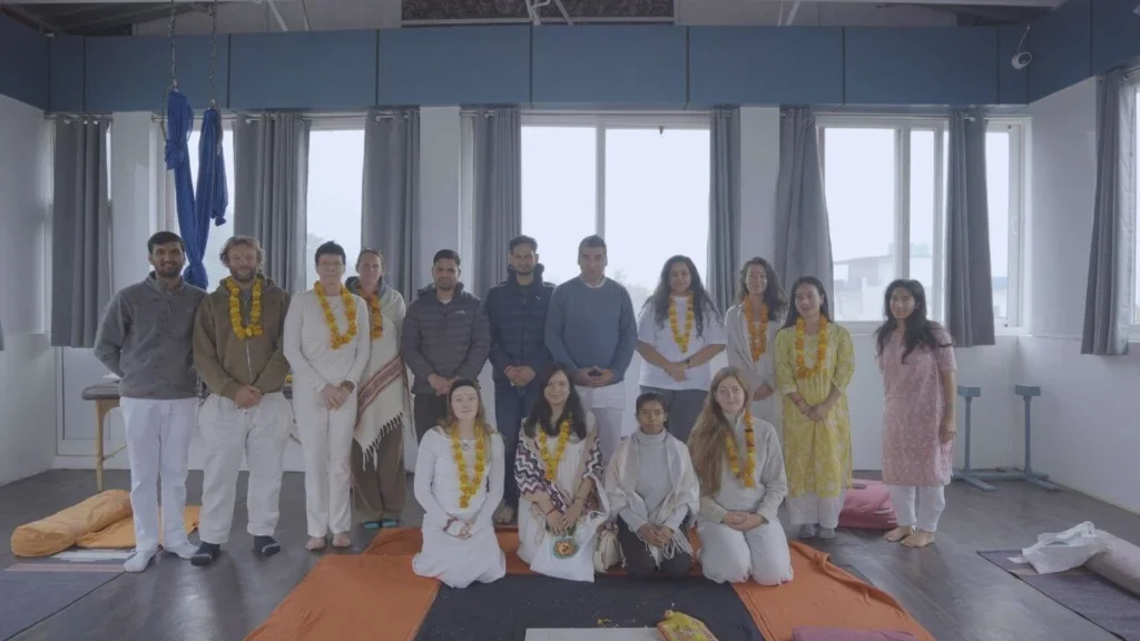 International students and teachers celebrating course completion during a 500 hour Yoga Teacher Training in Rishikesh India.