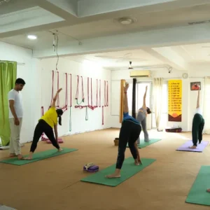 Neeraj Rayal guiding students through Ashtanga Yoga poses during a 10 Days Yoga Retreat in Rishikesh
