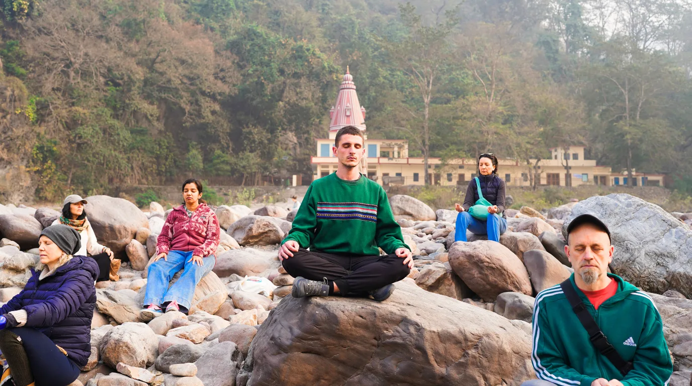 Participants practicing meditation outdoors during a 10 Days Yoga Retreat in Rishikesh