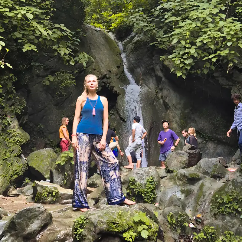 Yoga retreat participants exploring a waterfall during a 10 Days Yoga Retreat in Rishikesh