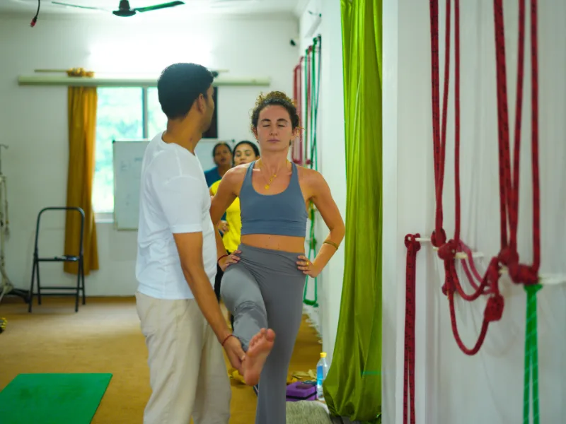 Yoga teacher assisting a participant with alignment during a 10 Days Yoga Retreat in Rishikesh