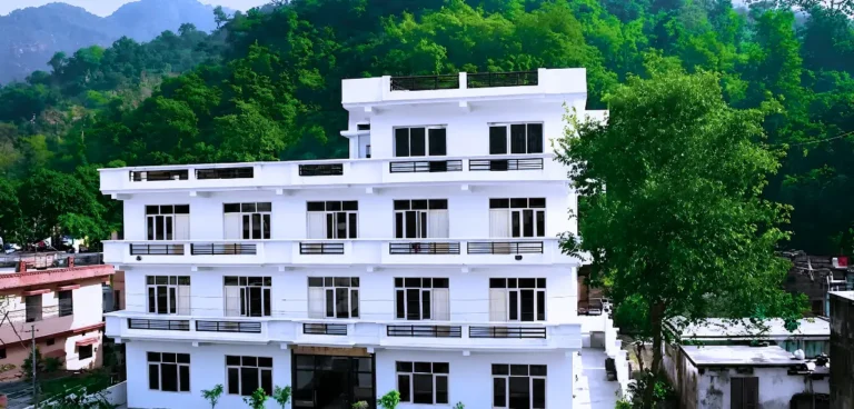 Yoga retreat center surrounded by lush green hills for a 10 Days Yoga Retreat in Rishikesh