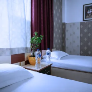 Twin-sharing room accommodation with clean beds and amenities for students enrolled in the 100 hour Kundalini yoga teacher training in Rishikesh.