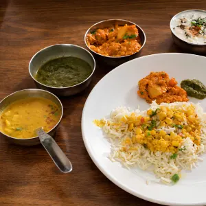 Traditional Indian sattvic vegetarian thali meal with rice, lentils, vegetables, and chutney served for students during 100 hour Kundalini yoga teacher training in Rishikesh.