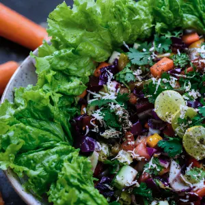 Fresh sattvic salad bowl with lettuce and carrots served during a 100 hour yoga teacher training in Rishikesh