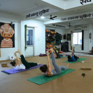 Students practicing asana postures inside the yoga shala during a 100 hour yoga teacher training in Rishikesh
