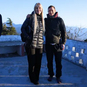 Two happy yoga students smiling together on a mountain viewpoint terrace during an excursion as part of the 300 hour yoga teacher training in rishikesh.
