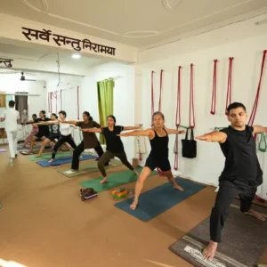 Neeraj Rayal guiding students through Ashtanga Yoga Warrior Pose during a 7 Days Yoga Retreat in Rishikesh