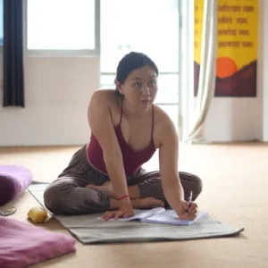 Student taking notes during an Ayurveda class taught by Rakesh at a 7 Days Yoga Retreat in Rishikesh