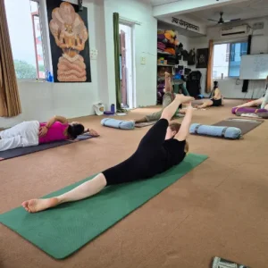 Rohit Kamboj guiding students through Hatha Yoga stretching exercises during a 7 Days Yoga Retreat in Rishikesh