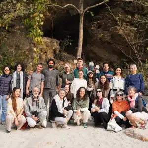 Group of students on an outdoor excursion near a cave during a sound healing course in Rishikesh