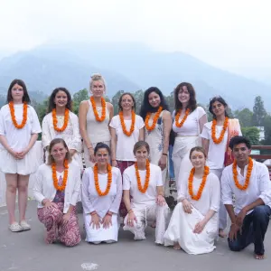 Students wearing marigold garlands during a sound healing course in Rishikesh
