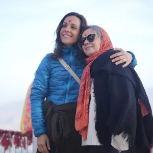 Two happy women embracing during a sound healing course in Rishikesh