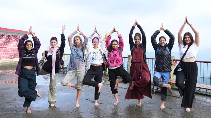 Participants practicing a group yoga pose during a 14 Days Yoga Retreat in Rishikesh