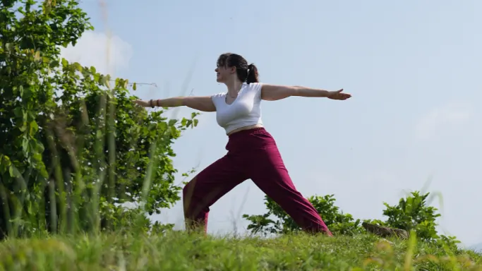 Participant practicing a warrior yoga pose during a 5 Days Yoga Retreat in Rishikesh