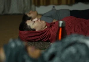 Yoga Nidra practice with participants resting comfortably during guided deep relaxation