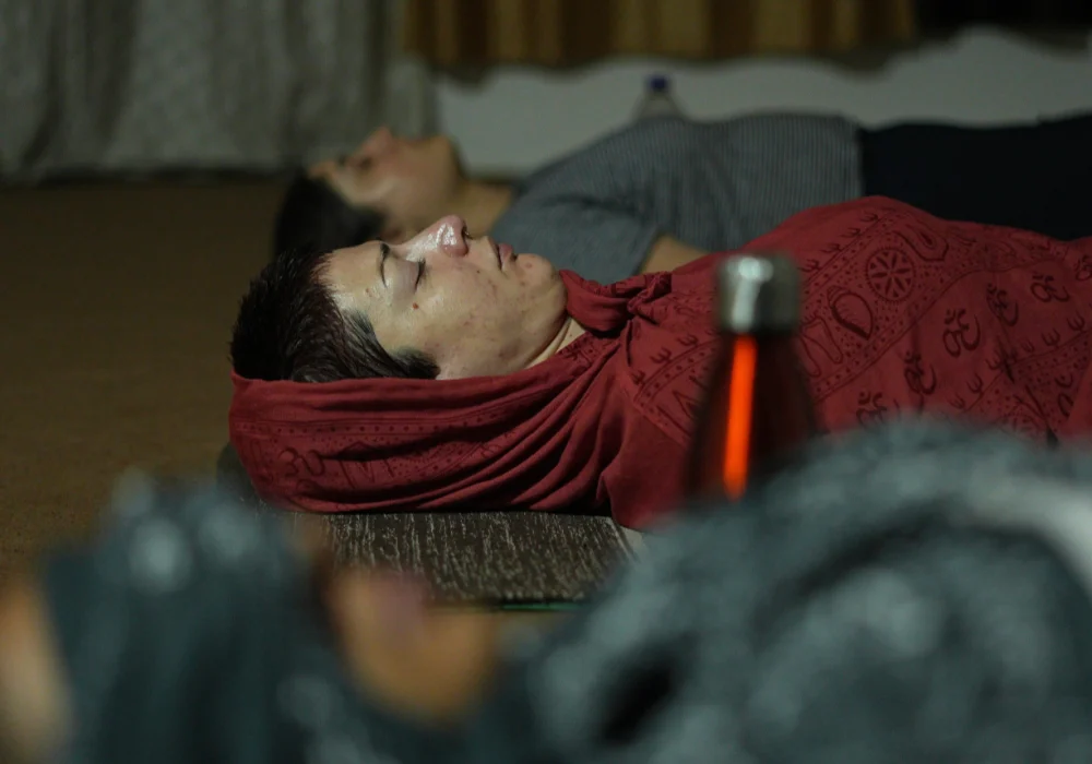 Yoga Nidra practice with participants resting comfortably during guided deep relaxation